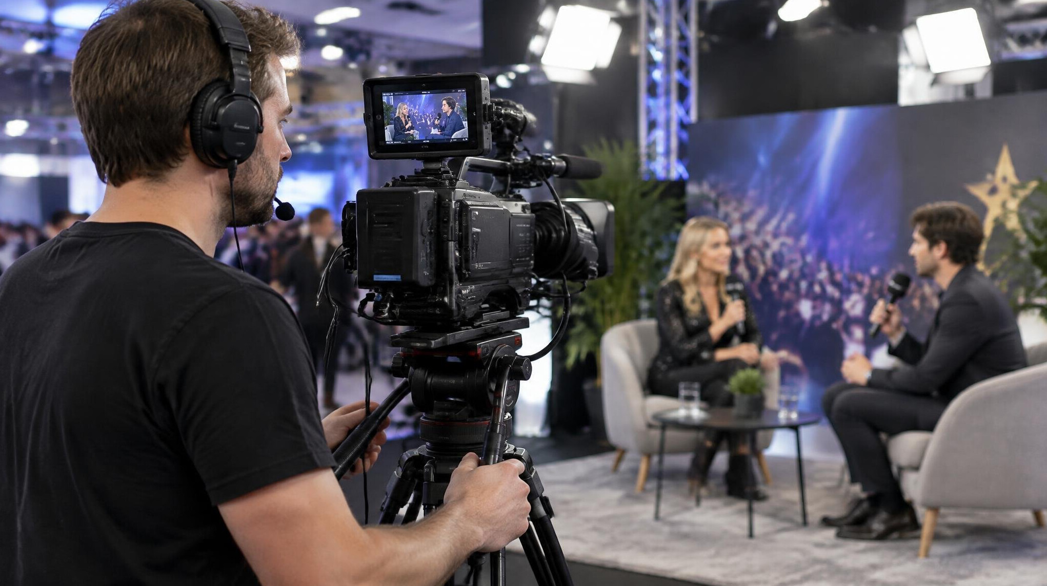 Camera operator filming an interview at an entertainment event