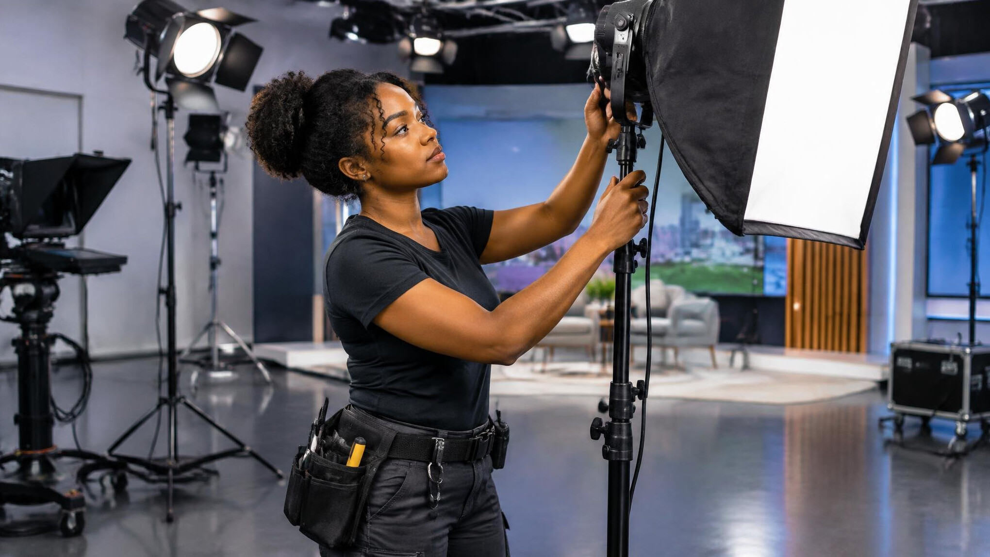 Lighting technician adjusting studio lights before a show